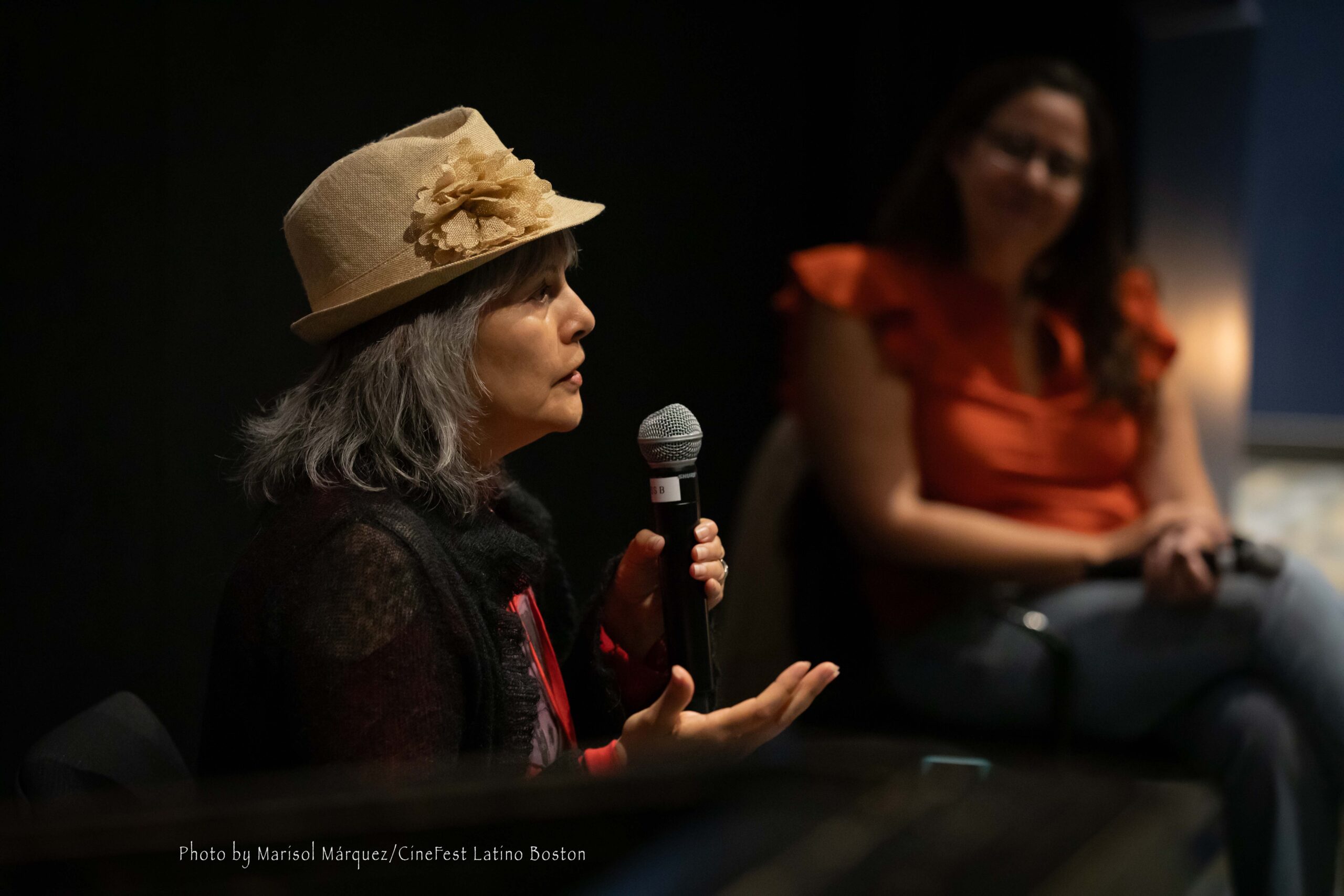 Close-up of director Mabel Valdiviezo speaking into a microphone during a Q&A session in San Francisco.